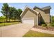 Side view of a home with a two car garage and gated driveway at 4112 Riverport Rd, Raleigh, NC 27616