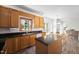 Open concept kitchen view featuring wood cabinets, a kitchen island, and an adjacent dining area at 4112 Riverport Rd, Raleigh, NC 27616