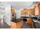 Bright kitchen featuring stainless steel refrigerator, a center island, wood cabinets and modern appliances at 4112 Riverport Rd, Raleigh, NC 27616