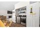 Laundry closet with stacked washer/dryer hookups, storage shelves, and adjacent dining room at 4112 Riverport Rd, Raleigh, NC 27616