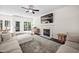 Bright living room features a fireplace, large TV, and French doors that open to a backyard deck at 4112 Riverport Rd, Raleigh, NC 27616