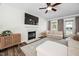 Cozy living room featuring a fireplace, large TV, comfortable seating, and ample natural light at 4112 Riverport Rd, Raleigh, NC 27616