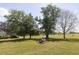 Spacious backyard with mature trees and a tranquil pond at 481 Firetower Rd, Louisburg, NC 27549