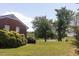 Spacious backyard with mature trees and a tranquil pond, house in view at 481 Firetower Rd, Louisburg, NC 27549