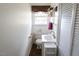 White bathroom with a white sink, storage units, toilet, and window at 481 Firetower Rd, Louisburg, NC 27549