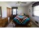 Bedroom with wooden floors, ceiling fan, window and double door closet at 481 Firetower Rd, Louisburg, NC 27549