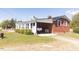 Side view showing the carport, sunroom, and red brick walls on this beautiful home at 481 Firetower Rd, Louisburg, NC 27549