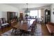 Elegant dining room with large windows, a formal table seating eight, and a display cabinet for storage at 481 Firetower Rd, Louisburg, NC 27549