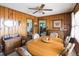 A wood-paneled dining room showcases a large round wood table, seating six, and a decorative ceiling fan at 481 Firetower Rd, Louisburg, NC 27549