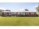 Brick ranch featuring a metal roof, manicured lawn, and beautiful landscaping at 481 Firetower Rd, Louisburg, NC 27549