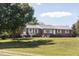 Brick ranch with manicured lawn, tidy landscaping, and white trim at 481 Firetower Rd, Louisburg, NC 27549