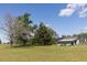 Lush lawn with mature trees and a utility building enhance this property at 481 Firetower Rd, Louisburg, NC 27549