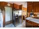 Bright kitchen featuring stainless steel refrigerator and classic wooden cabinets with ample counter space at 481 Firetower Rd, Louisburg, NC 27549