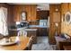 Open-concept eat-in kitchen boasting wood cabinets, retro appliances, and adjacent dining area at 481 Firetower Rd, Louisburg, NC 27549