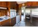 View of kitchen with stainless steel refrigerator, appliances, and adjacent eat-in area with lots of light at 481 Firetower Rd, Louisburg, NC 27549