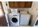 Laundry room features washer and dryer, with cabinets above appliances at 481 Firetower Rd, Louisburg, NC 27549