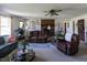 Inviting living room featuring a brick fireplace, plush seating, and natural light, creating a warm atmosphere at 481 Firetower Rd, Louisburg, NC 27549