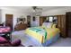 Sunlit main bedroom suite featuring a queen bed, a wooden headboard, and ample storage space and closet at 481 Firetower Rd, Louisburg, NC 27549