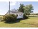 Quaint outbuilding featuring a white exterior and surrounded by lush greenery at 481 Firetower Rd, Louisburg, NC 27549