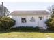 Quaint outbuilding featuring a white exterior and surrounded by lush greenery at 481 Firetower Rd, Louisburg, NC 27549