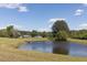 Beautiful pond with surrounding greenery and a tranquil setting at 481 Firetower Rd, Louisburg, NC 27549