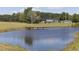 Scenic view of the pond with a wooden bridge and home in the background at 481 Firetower Rd, Louisburg, NC 27549