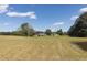 Expansive property showcasing a large field with mature trees and buildings at 481 Firetower Rd, Louisburg, NC 27549