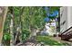Lush backyard with plenty of trees and shrubs, a shed, and a staircase leading to the house at 4828 Forest Highland Dr, Raleigh, NC 27604