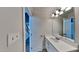 Bright bathroom with large vanity and sink and with an entrance to the main hallway at 4828 Forest Highland Dr, Raleigh, NC 27604