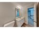 Bathroom with a single sink vanity, framed mirror, and access to the upstairs hallway at 4828 Forest Highland Dr, Raleigh, NC 27604