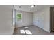 Carpeted bedroom featuring natural light from the window and a spacious built-in closet at 4828 Forest Highland Dr, Raleigh, NC 27604