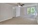 Large carpeted bedroom with ceiling fan and closet at 4828 Forest Highland Dr, Raleigh, NC 27604