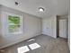 Comfortable carpeted bedroom featuring a window and a built-in closet at 4828 Forest Highland Dr, Raleigh, NC 27604