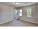 Spacious bedroom with neutral walls, plush carpet, and a window offering natural light at 4828 Forest Highland Dr, Raleigh, NC 27604
