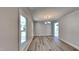 Bright dining room features wood floors, a chandelier, and large windows that provide plenty of natural light at 4828 Forest Highland Dr, Raleigh, NC 27604