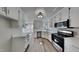 Modern kitchen with stainless steel appliances, plenty of cabinet space, and a view to the breakfast nook at 4828 Forest Highland Dr, Raleigh, NC 27604