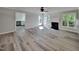 Bright and airy living room with fireplace, ceiling fan, and door to outside deck at 4828 Forest Highland Dr, Raleigh, NC 27604