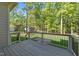 Lovely back deck overlooking a well-maintained lawn and picturesque wooded area at 4924 Theys Rd, Raleigh, NC 27606