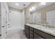 A bright bathroom with double sinks, granite countertops, and a combined tub and shower with white subway tile at 4924 Theys Rd, Raleigh, NC 27606
