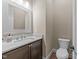 Powder room features a white marble countertop and decorative framed mirror at 4924 Theys Rd, Raleigh, NC 27606