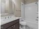 This bathroom features white subway tiles in the shower/tub and a marble countertop with dark-brown cabinets at 4924 Theys Rd, Raleigh, NC 27606