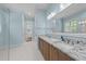 Bathroom featuring dual sinks, granite countertops, and natural light at 4924 Theys Rd, Raleigh, NC 27606