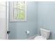 Cozy powder room featuring a window and toilet at 4924 Theys Rd, Raleigh, NC 27606