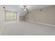 Spacious bedroom with neutral color palette, large window, and ceiling fan at 4924 Theys Rd, Raleigh, NC 27606