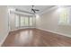 Spacious bedroom showcasing hardwood floors, bay windows, and modern ceiling fan at 4924 Theys Rd, Raleigh, NC 27606