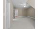 Spacious bedroom featuring a ceiling fan, plush carpet, neutral walls, and an adjoining room through doorway at 4924 Theys Rd, Raleigh, NC 27606