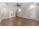Large bedroom featuring hardwood floors and doors leading to a bath and exterior at 4924 Theys Rd, Raleigh, NC 27606