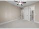 Bedroom features a ceiling fan and access to a walk-in closet at 4924 Theys Rd, Raleigh, NC 27606