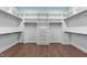 Walk-in closet with custom shelving and a convenient central drawer unit at 4924 Theys Rd, Raleigh, NC 27606
