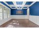 Elegant dining room with coffered ceiling, large windows, and stylish lighting at 4924 Theys Rd, Raleigh, NC 27606